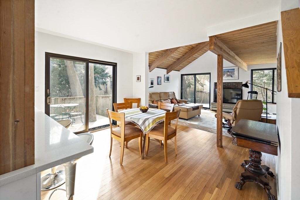 58 Garden Street, Unit F Cambridge, MA 02138 - Photo 8 of 25 a living room with furniture a wooden floor and a large window