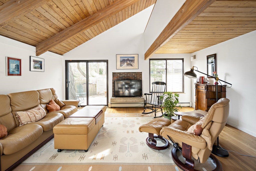 58 Garden Street, Unit F Cambridge, MA 02138 - Photo 10 of 25 a living room with furniture a fireplace and a large window