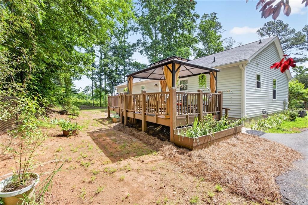 3771 Castleberry Road Cumming, GA 30040 - Photo 45 of 69 a view of a house with a yard and sitting area