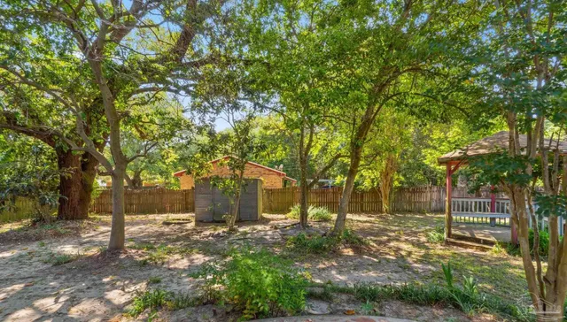 a view of a tree in front of a house