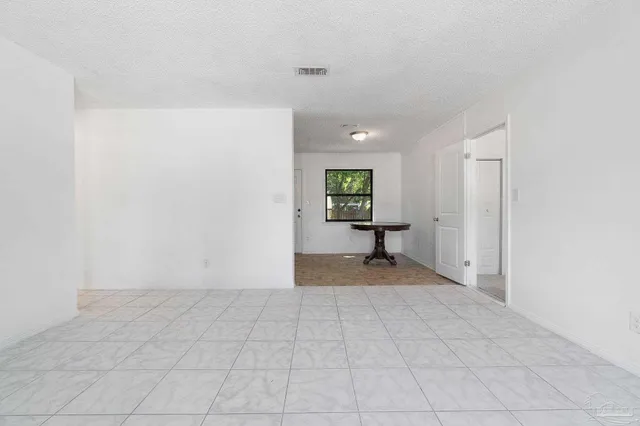 a view of an empty room and a window
