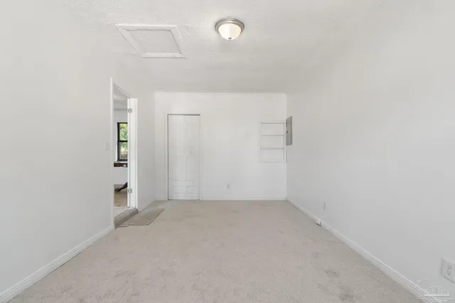 an empty room with a empty space and windows