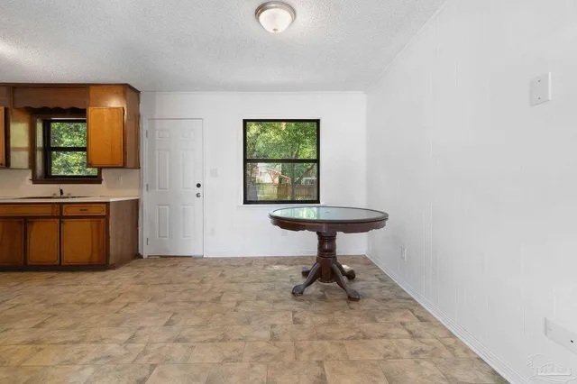 an empty room with a sink and mirror