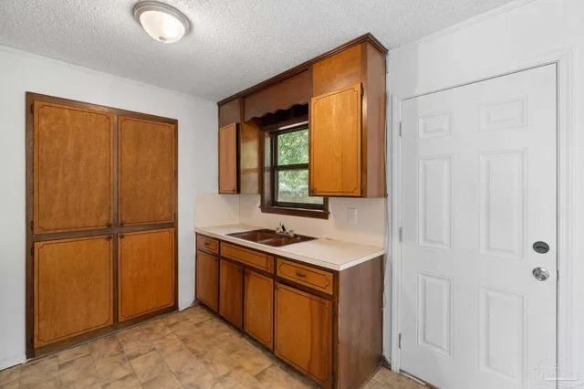 a kitchen with a refrigerator and a sink
