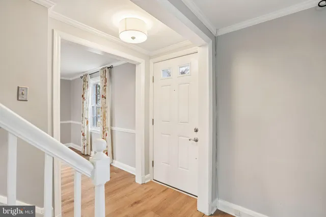 a view of a hallway with wooden floor and entryway