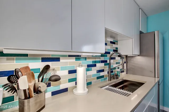 a kitchen with lots of white appliances and cabinets