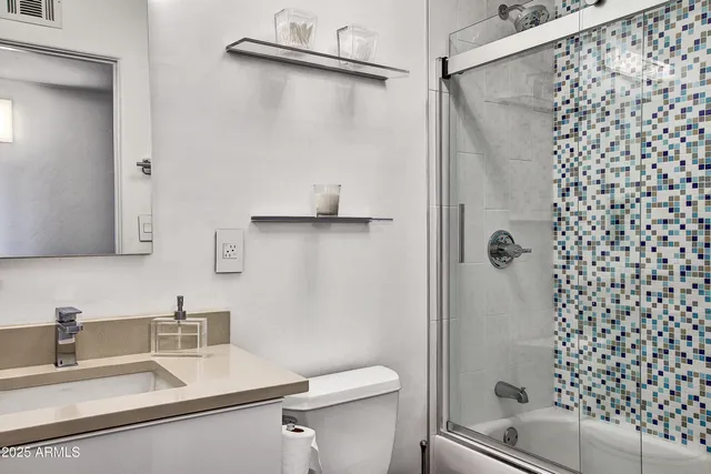 a bathroom with a sink toilet and shower
