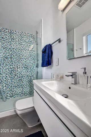 a bathroom with a sink toilet and shower