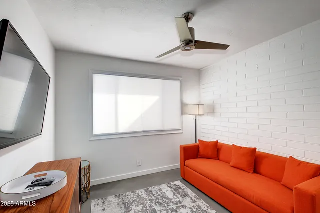 a living room with furniture a couch and a flat screen tv