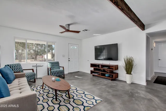 a living room with furniture and a flat screen tv
