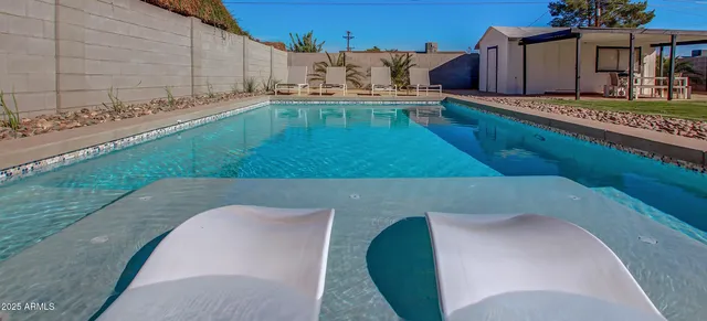 a view of swimming pool with a yard