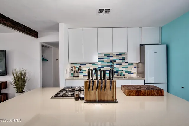 a kitchen with refrigerator and window