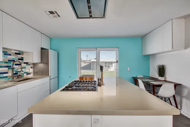 a kitchen with a table and chairs