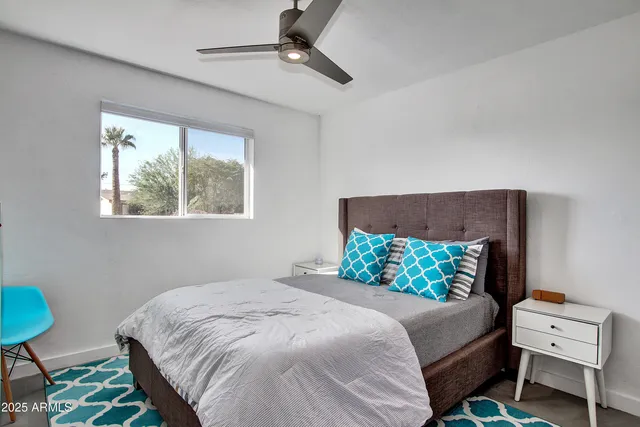 a bedroom with a bed dresser and a window