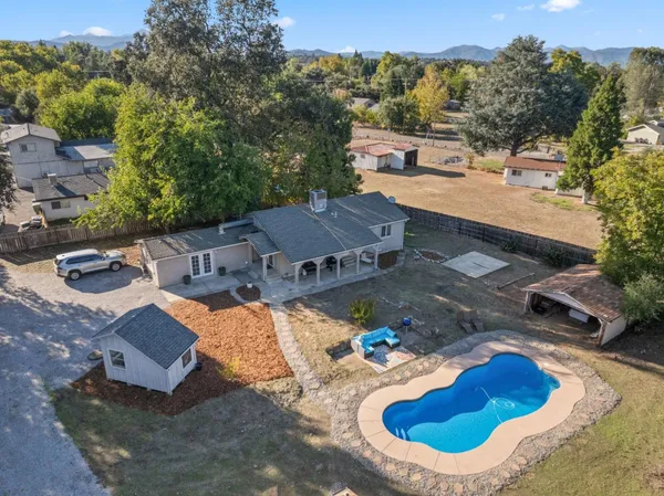 an aerial view of a house with yard swimming pool and outdoor seating