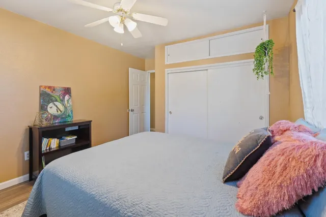 a bedroom with a bed table and a window