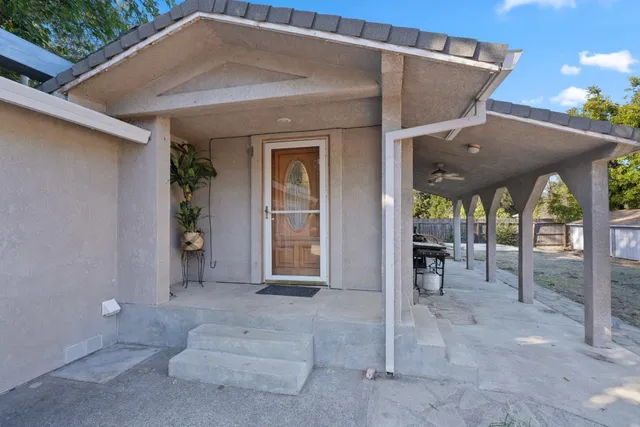 a view of a patio with table and chairs