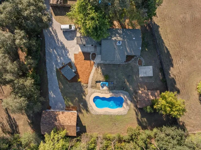 an aerial view of a house with a yard and garden