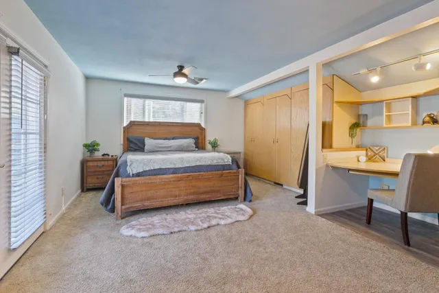 a bedroom with a bed and a furniture