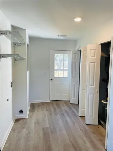 an empty room with wooden floor and a window