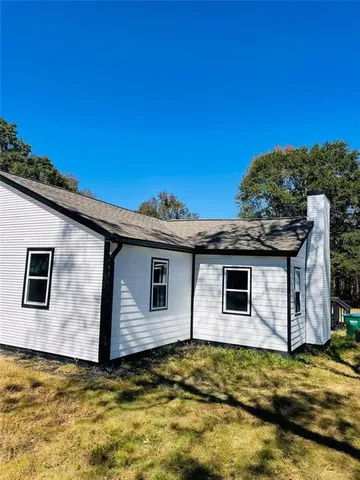 a view of a backyard of house with large trees