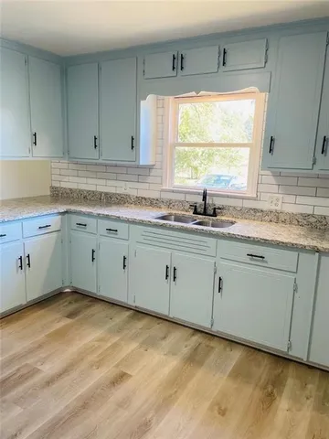 a kitchen with sink cabinets and window