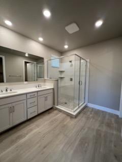 11517 Lagarto Way Rancho Cordova, CA 95742 - Photo 4 of 9 a bathroom with a double vanity sink double mirror and shower