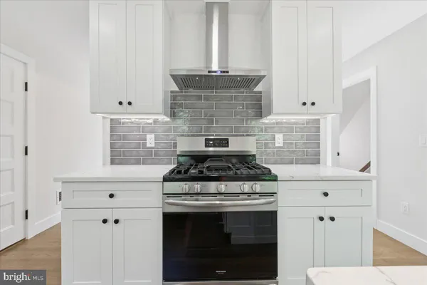 a stove top oven sitting inside of a kitchen