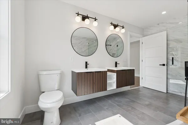 a bathroom with a toilet a sink and a mirror