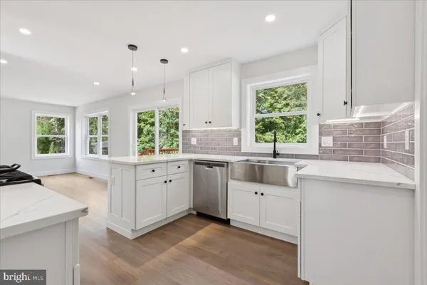 a kitchen with white cabinets and white appliances