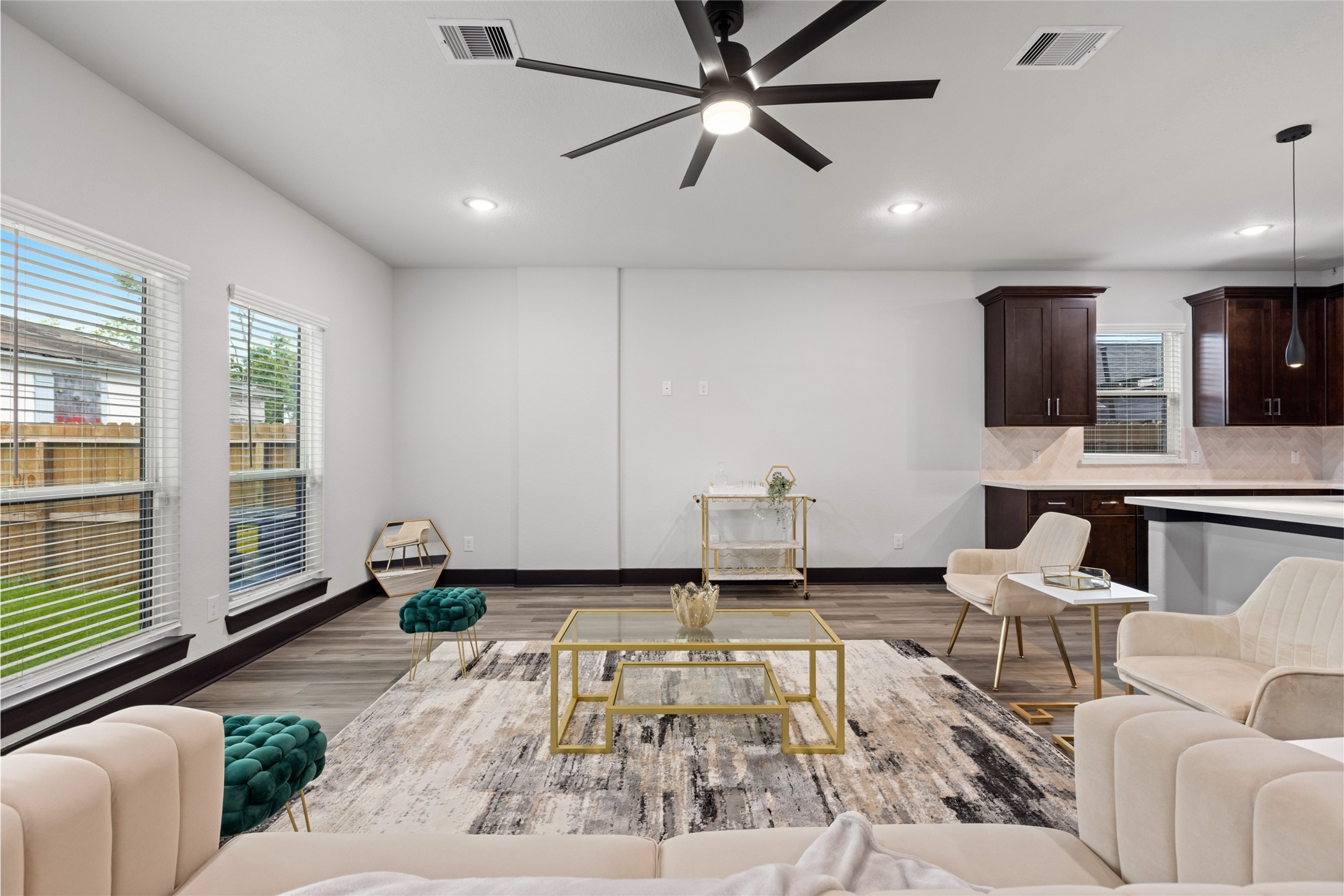 4435 Maggie Street, Unit B Houston, TX 77051 - Photo 11 of 37 Open-concept living area with large windows allowing natural light to fill the space. The room features stylish furnishings, a contemporary ceiling fan creating an inviting and comfortable atmosphere.