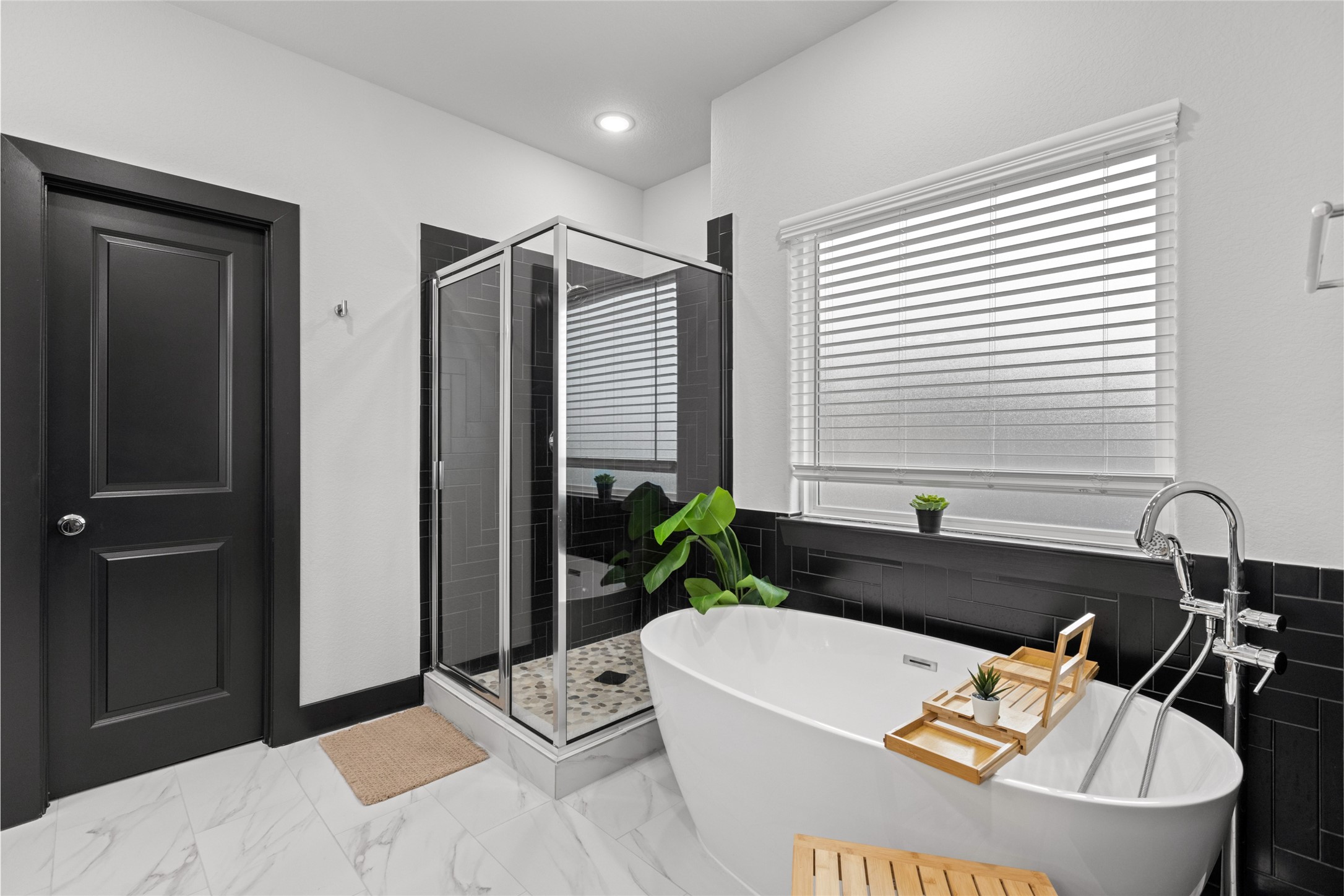 4435 Maggie Street, Unit B Houston, TX 77051 - Photo 19 of 37 Fall in love with the sleek freestanding tub and a glass-enclosed shower.