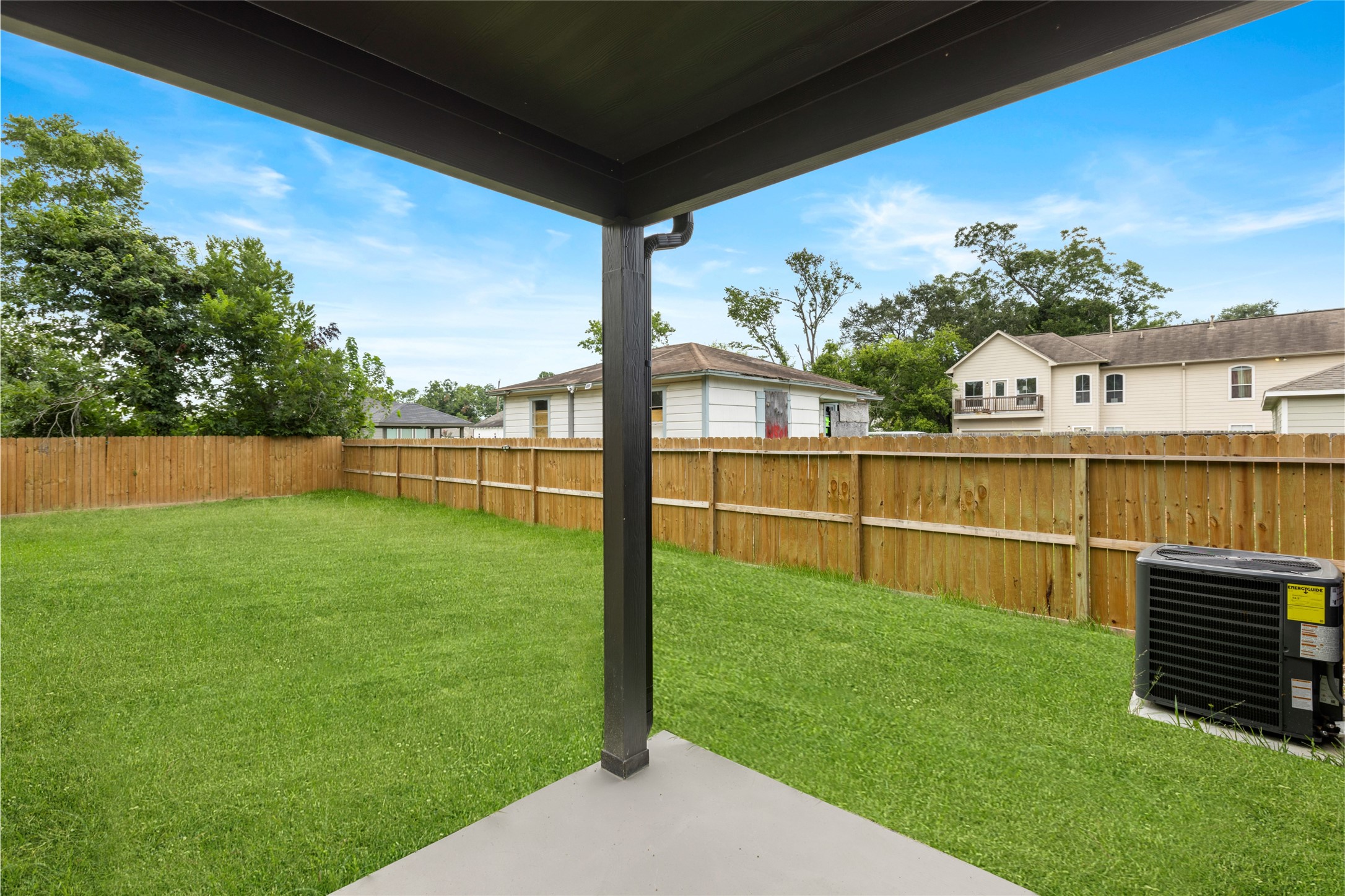 4435 Maggie Street, Unit B Houston, TX 77051 - Photo 29 of 37 Rare, spacious backyard with a well-maintained lawn, enclosed by a wooden fence. The yard includes an oversized covered patio, ideal for outdoor relaxation.