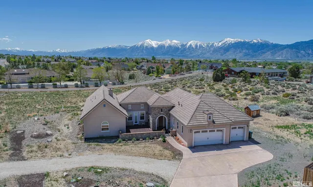 a view of a house with a mountain in the background