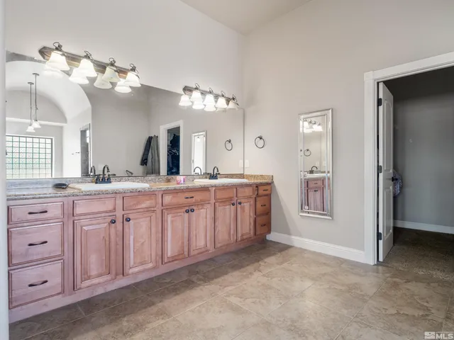 a bedroom with a bed and a wooden floor