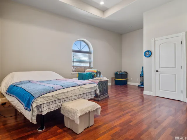 a bedroom with a bed and a large window
