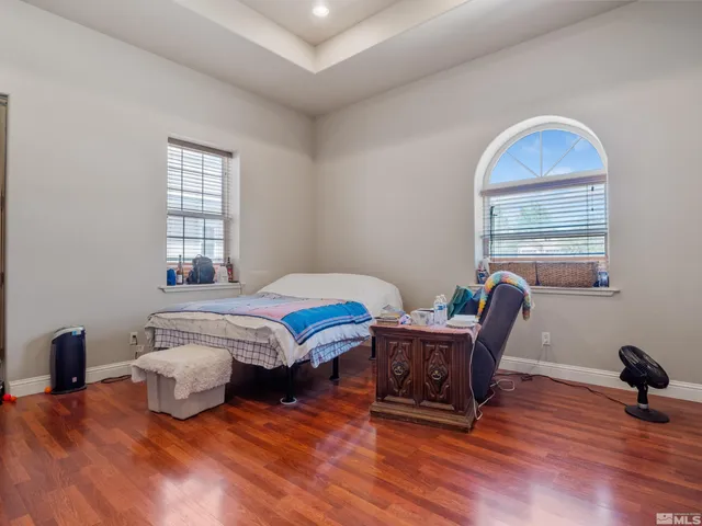 a bathroom with a granite countertop sink a toilet and a mirror