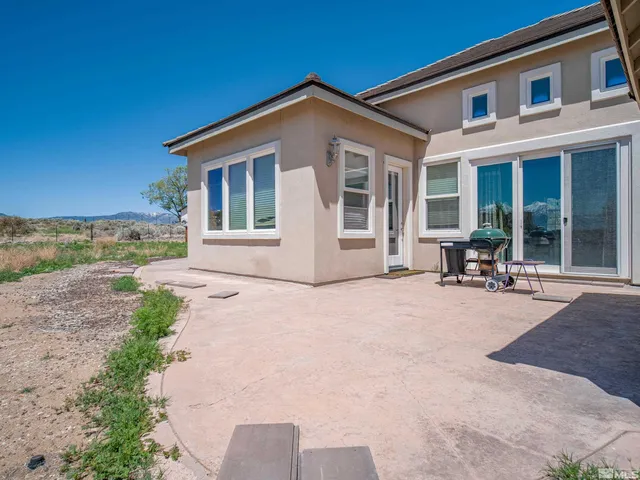 a view of a house with a yard and sitting area