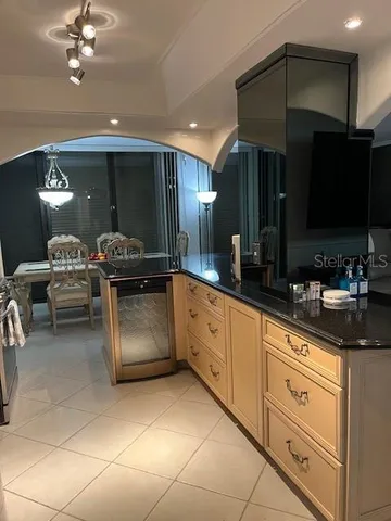 a view of a dining room with furniture and chandelier