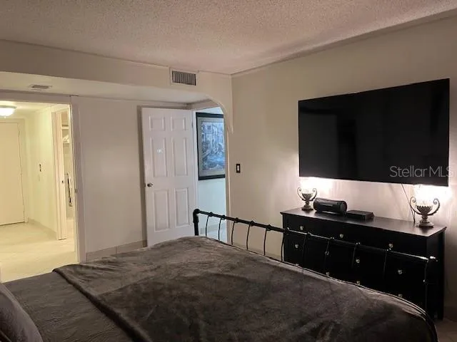 a bed sitting in a bedroom next to a window