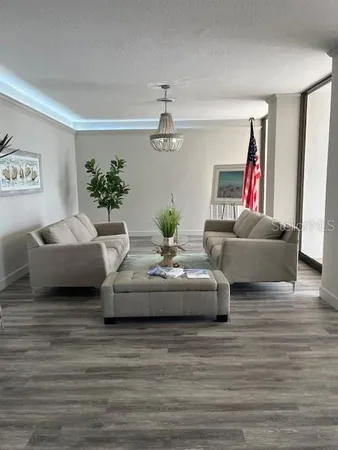 a living room with furniture and a chandelier