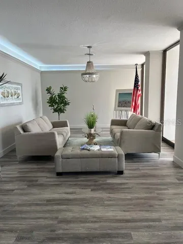 a living room with furniture and a chandelier