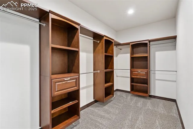 a view of walk in closet with empty racks