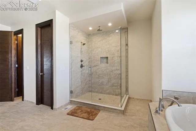 a bathroom with a shower and a sink