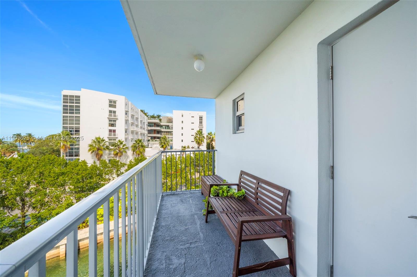 1674 Bay Road, Unit 401 Miami Beach, FL 33139 - Photo 16 of 33 a view of balcony with wooden floor and seating space