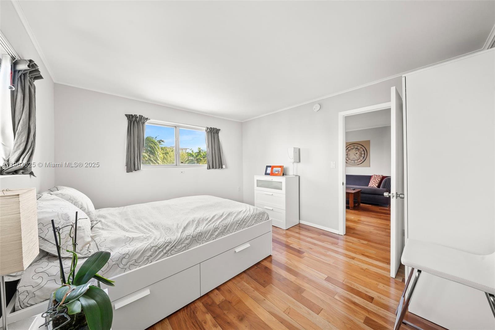 1674 Bay Road, Unit 401 Miami Beach, FL 33139 - Photo 17 of 33 a bedroom with a bed and a window