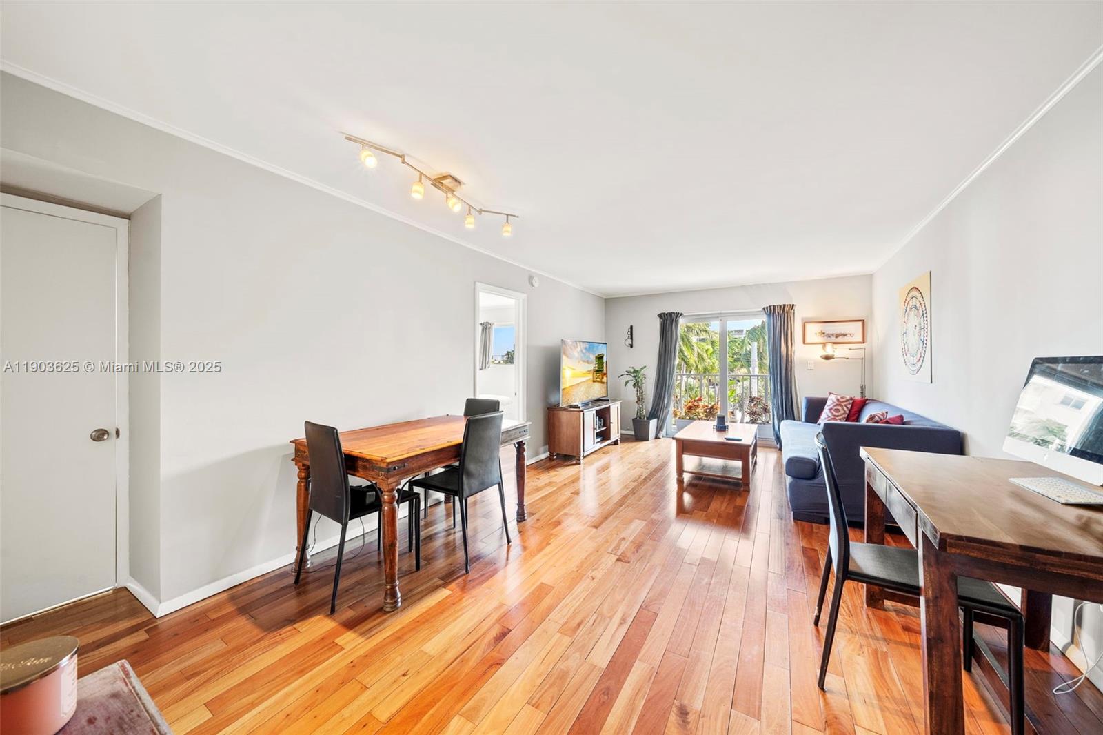 1674 Bay Road, Unit 401 Miami Beach, FL 33139 - Photo 2 of 33 a living room with furniture a dining table and wooden floor