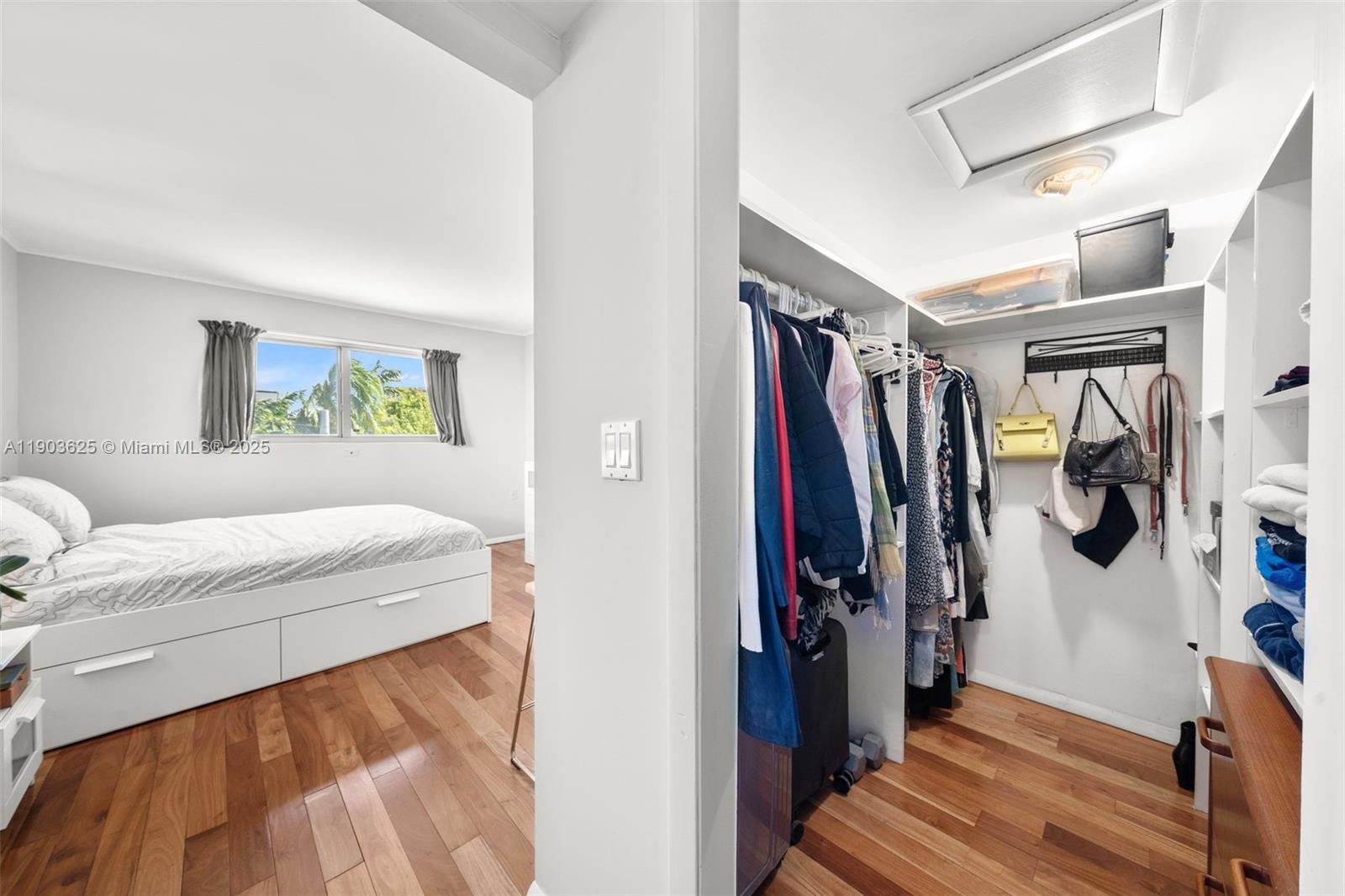 1674 Bay Road, Unit 401 Miami Beach, FL 33139 - Photo 23 of 33 a view of walk in closet with clothes and shoes