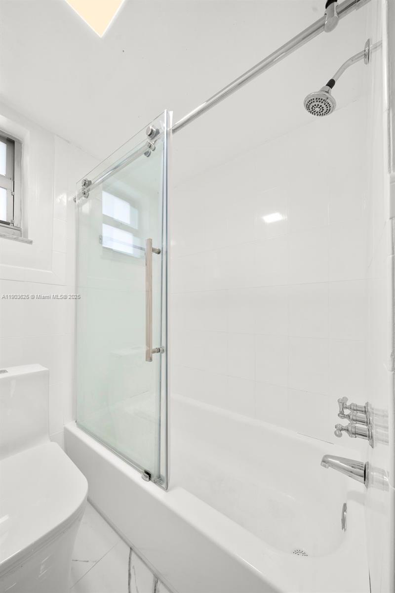 1674 Bay Road, Unit 401 Miami Beach, FL 33139 - Photo 25 of 33 a bathroom with a shower and a toilet