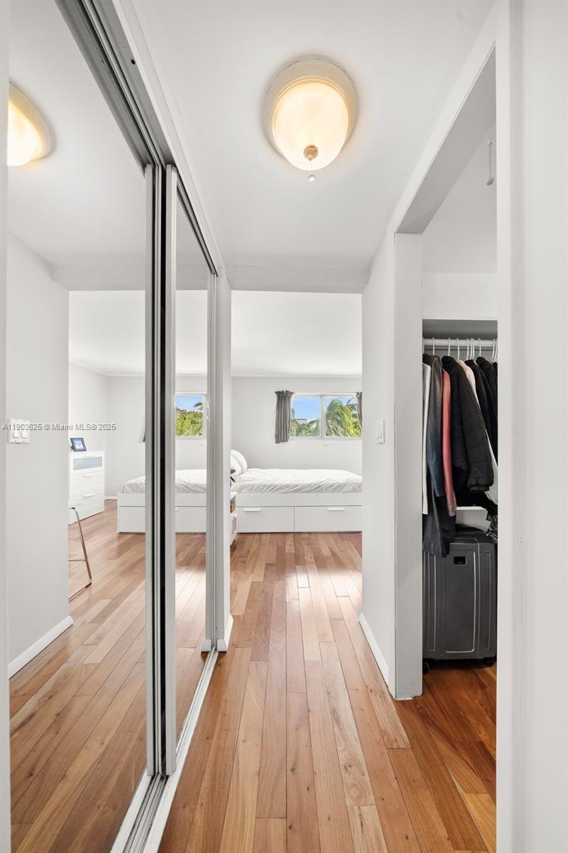 1674 Bay Road, Unit 401 Miami Beach, FL 33139 - Photo 27 of 33 a view of a hallway view with wooden floor and staircase